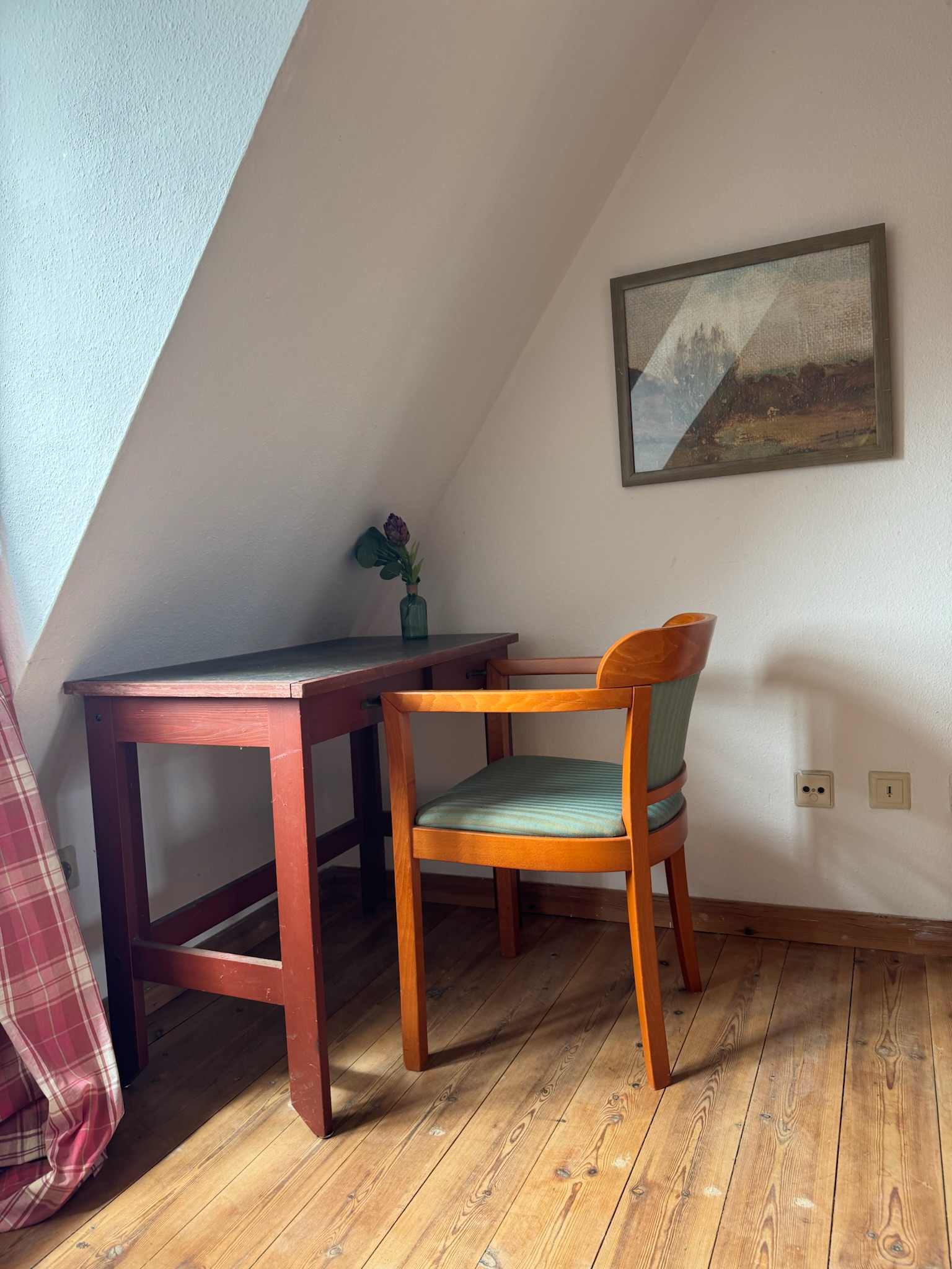 Dark desk under sloped ceiling